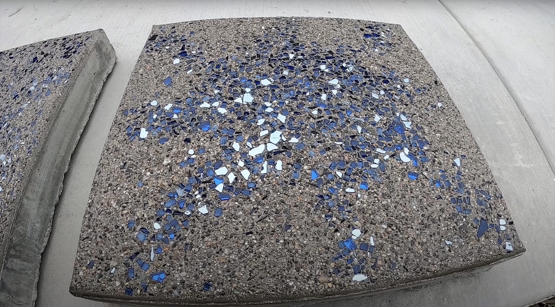 Decorative Concrete Finishes - Exposed Aggregate with Color Decorative concrete sample showing blue and white aggregate finish with exposed aggregate texture