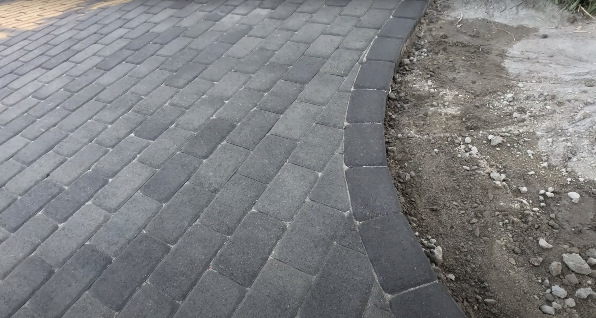 Concrete Paver Installation - Herringbone Pattern Construction Concrete paver installation in progress showing herringbone pattern and base preparation