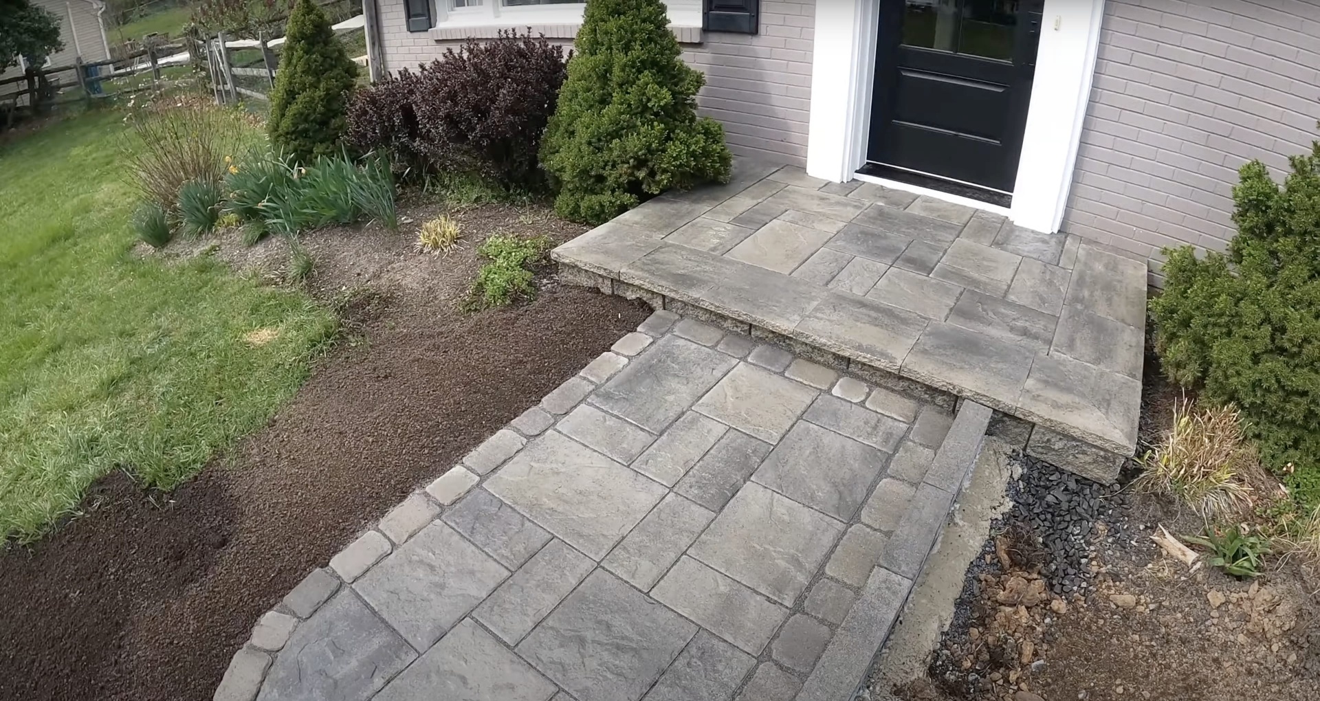 Multi-Level Stamped Concrete Patio with Decorative Steps Multi-level stamped concrete patio and steps with decorative borders and landscaping